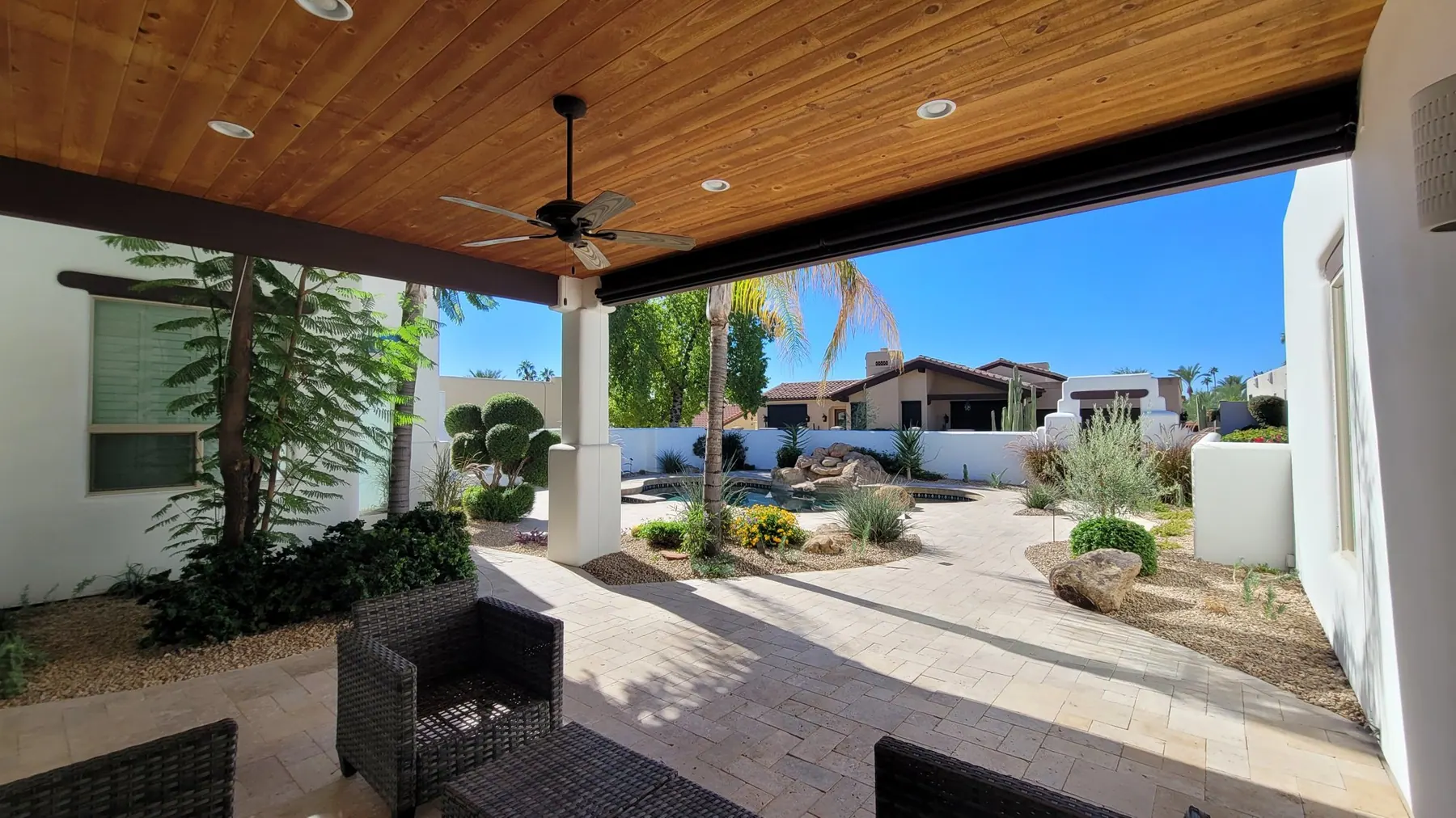 Modern Phoenix pool deck with pavers and drought-tolerant lawn area